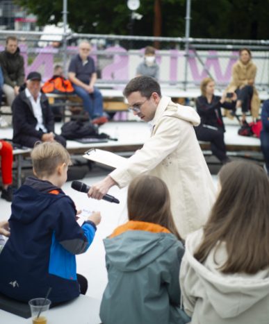 Simon Hauser moderiert vor Publikum
